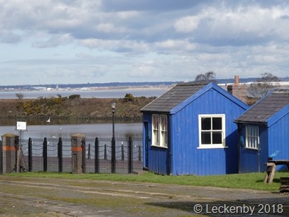 Not bathing huts but offices overlooking the Ship Canal, the Mersey and John Lennon Airport
